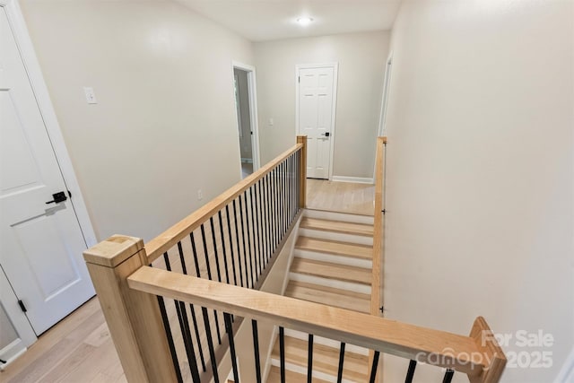 staircase with hardwood / wood-style floors