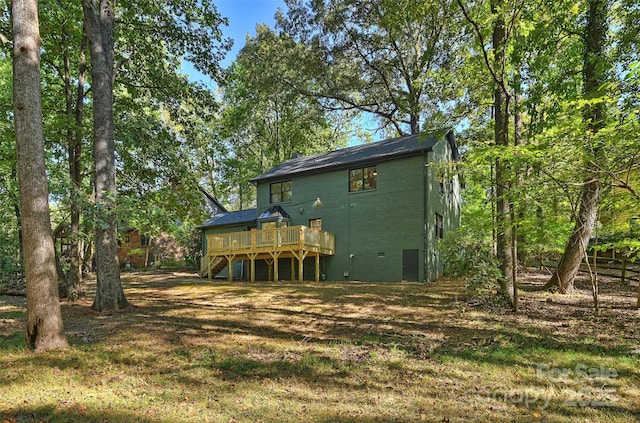 rear view of property featuring a wooden deck