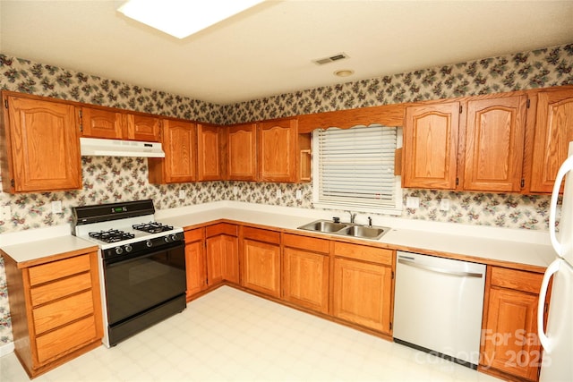 kitchen with black range with gas stovetop, sink, white fridge, and stainless steel dishwasher