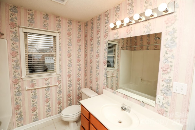 bathroom featuring tile patterned floors, vanity, a textured ceiling, and toilet