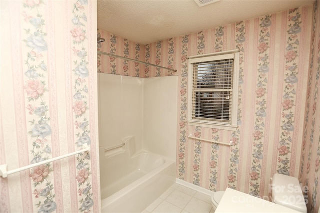 bathroom with tile patterned floors, a textured ceiling, toilet, and shower / tub combination