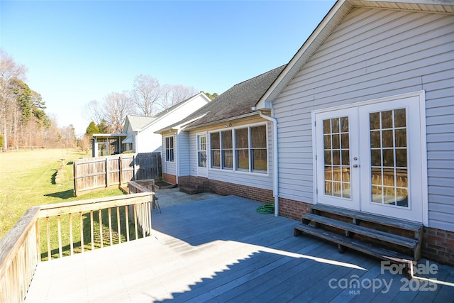 deck with french doors and a yard