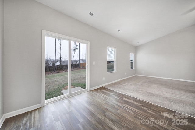 unfurnished room featuring hardwood / wood-style floors and vaulted ceiling