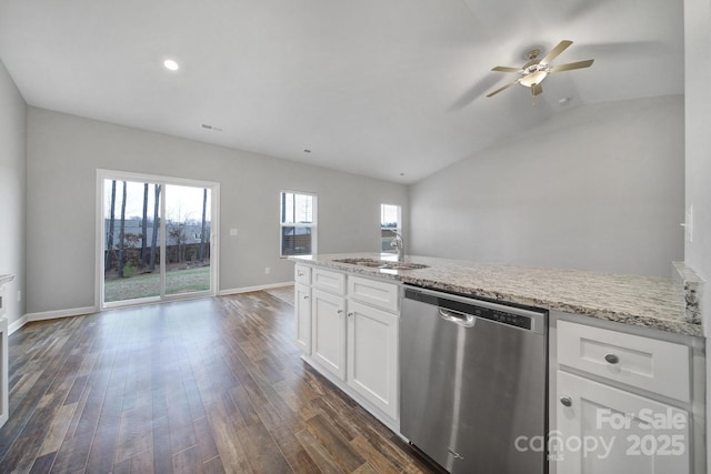 kitchen with light stone countertops, dishwasher, sink, lofted ceiling, and white cabinets