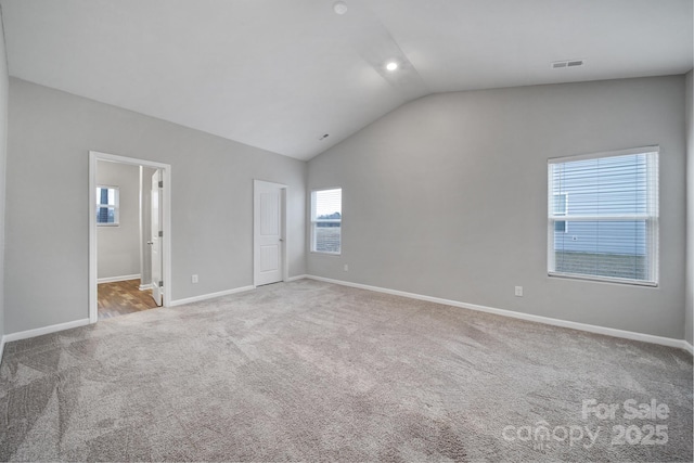 unfurnished bedroom featuring carpet flooring and lofted ceiling