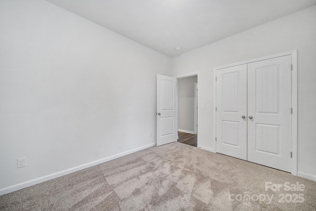 unfurnished bedroom with carpet flooring and a closet