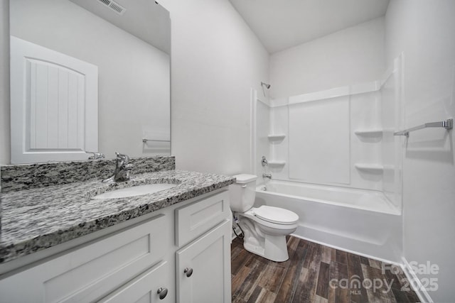 full bathroom featuring wood-type flooring, vanity, toilet, and shower / bathtub combination