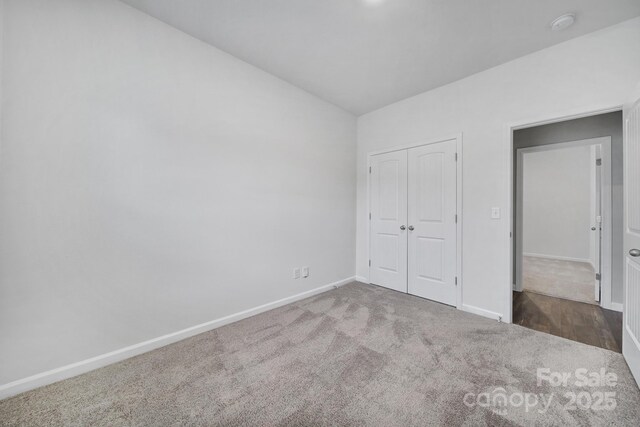 unfurnished bedroom featuring carpet and a closet