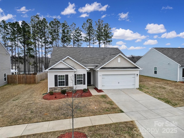 view of front of home featuring a front yard and a garage