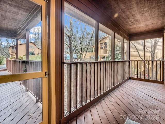 unfurnished sunroom featuring wooden ceiling