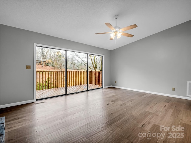 unfurnished room with hardwood / wood-style flooring, ceiling fan, and a textured ceiling