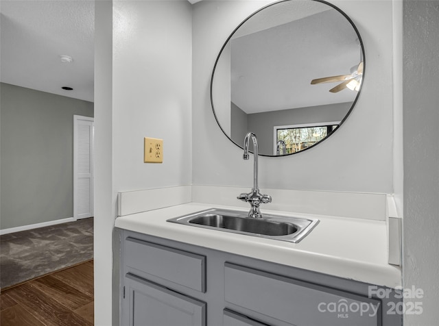 bathroom featuring ceiling fan, hardwood / wood-style floors, and vanity