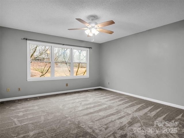 carpeted empty room featuring a textured ceiling and ceiling fan