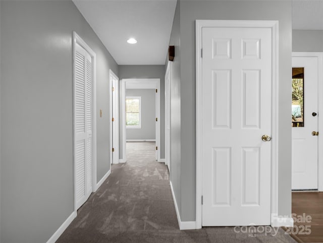 hallway with dark carpet