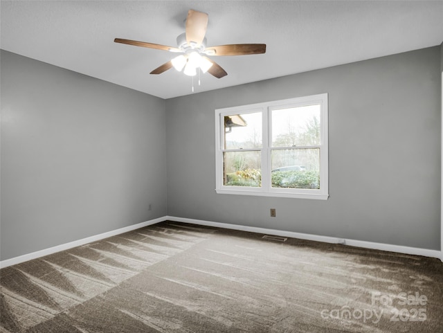 carpeted empty room featuring ceiling fan