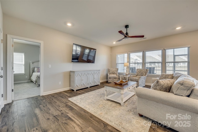 living room with ceiling fan and dark hardwood / wood-style floors