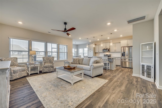 living room featuring wood-type flooring and ceiling fan