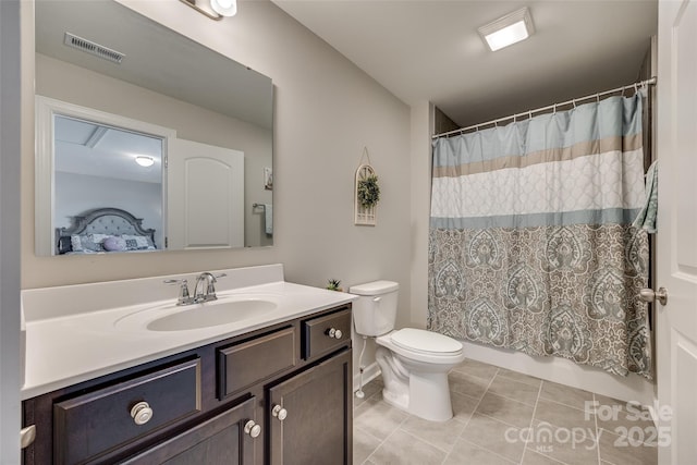 bathroom featuring tile patterned flooring, a shower with curtain, vanity, and toilet