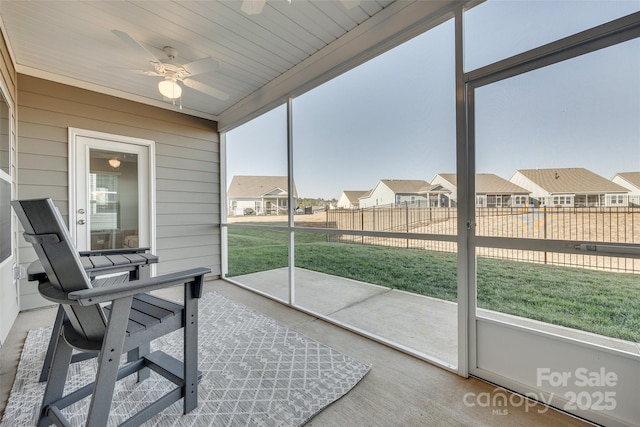 sunroom / solarium featuring ceiling fan