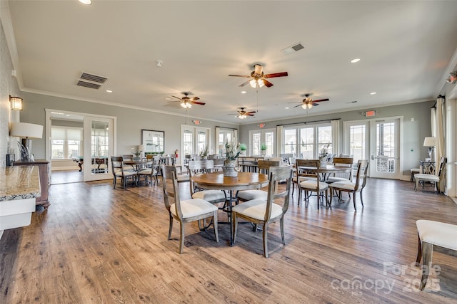 dining area with crown molding, french doors, and plenty of natural light