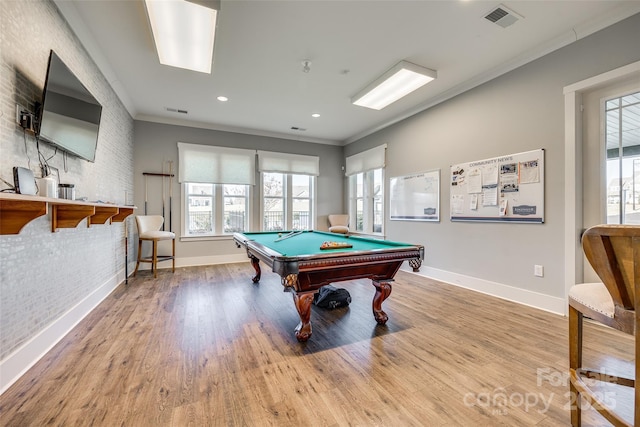 playroom with crown molding, light hardwood / wood-style floors, brick wall, and pool table