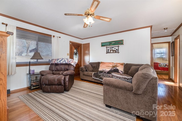 living room featuring hardwood / wood-style flooring, ceiling fan, and ornamental molding