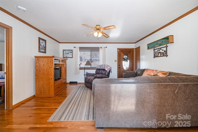 living room with ceiling fan, wood-type flooring, and crown molding