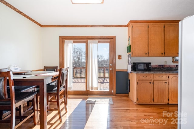 kitchen with crown molding and light wood-type flooring