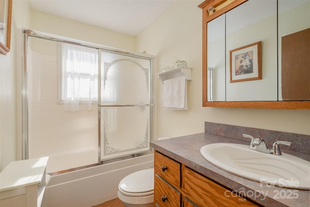 full bathroom featuring vanity, toilet, and enclosed tub / shower combo