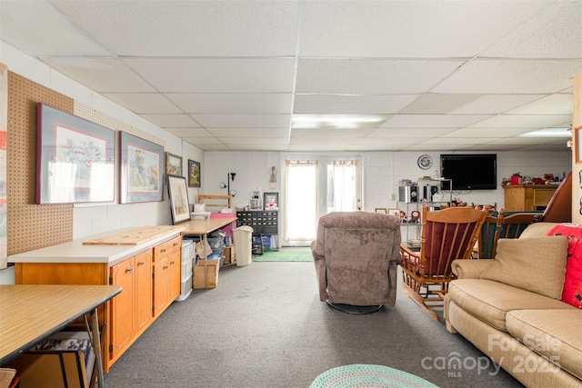 living room with a drop ceiling