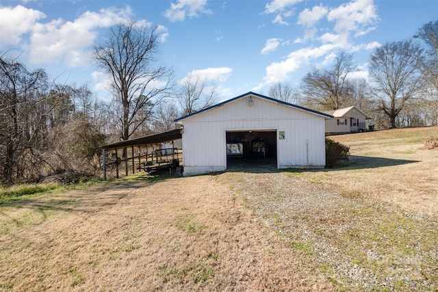 view of outdoor structure with a yard and a garage