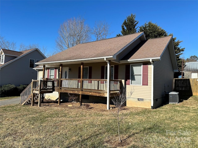 view of front of home featuring central air condition unit, a front lawn, and covered porch