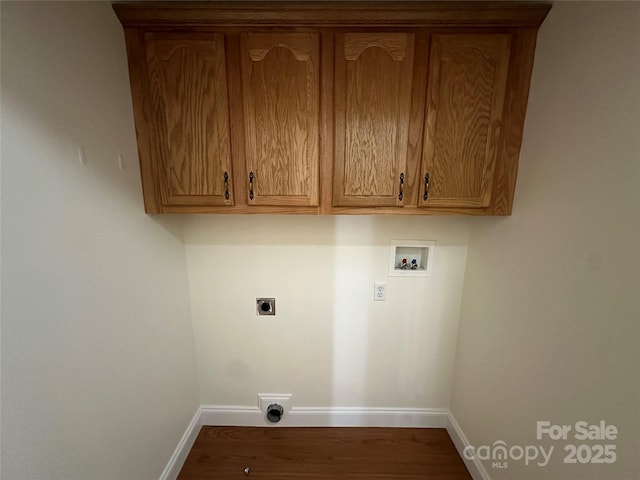 clothes washing area featuring washer hookup, electric dryer hookup, and cabinets