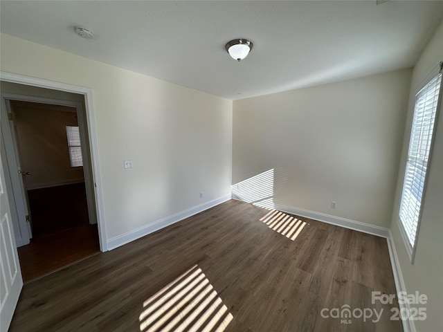 empty room with dark hardwood / wood-style floors