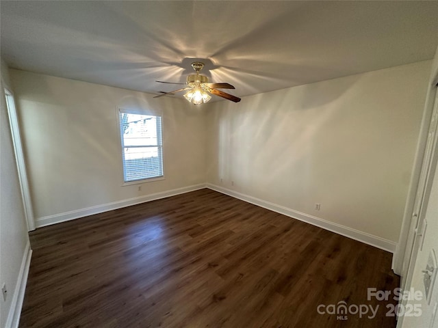 unfurnished room featuring ceiling fan and dark hardwood / wood-style floors