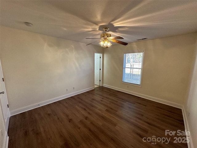 spare room featuring ceiling fan and dark hardwood / wood-style flooring