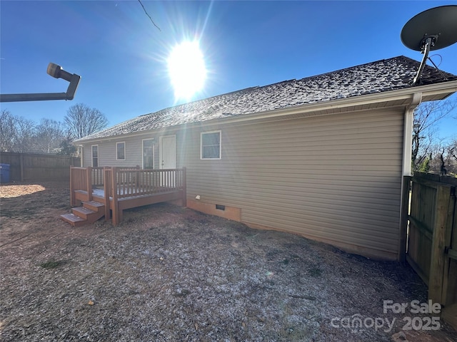 rear view of house featuring a deck