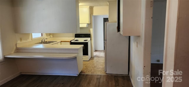 kitchen with sink, dark hardwood / wood-style floors, ventilation hood, kitchen peninsula, and white appliances