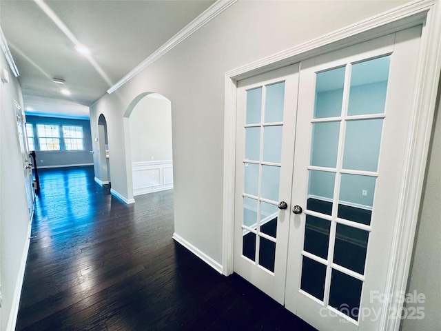 hallway with ornamental molding, french doors, and dark hardwood / wood-style floors