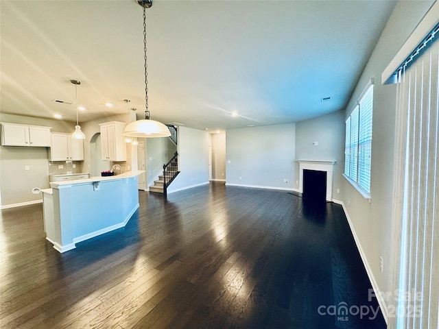 unfurnished living room with dark hardwood / wood-style floors