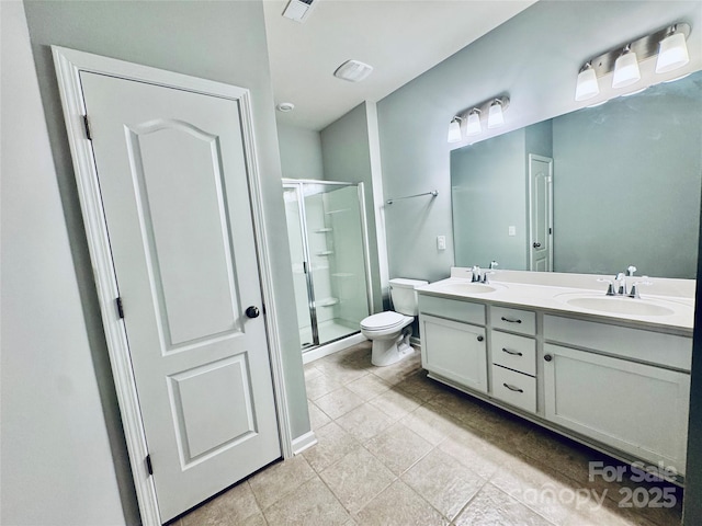 bathroom featuring toilet, an enclosed shower, vanity, and tile patterned flooring