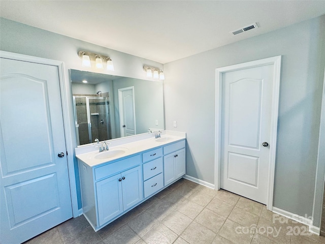 bathroom featuring walk in shower, vanity, and tile patterned floors