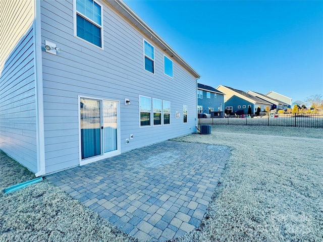 rear view of house featuring a patio and cooling unit