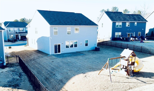 back of house with a playground