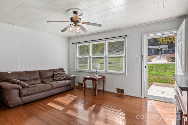 living room with wood-type flooring and ceiling fan