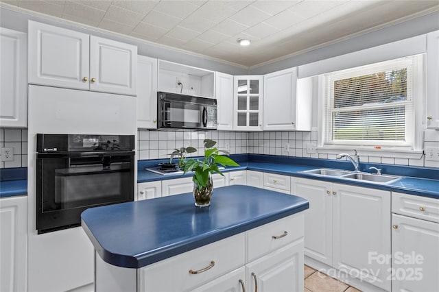 kitchen featuring tasteful backsplash, ornamental molding, sink, black appliances, and white cabinetry