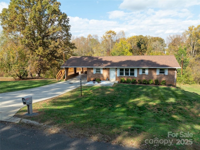 ranch-style house featuring a carport and a front yard