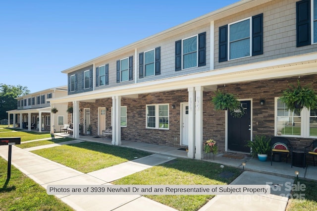 view of front of property with a front yard and a porch