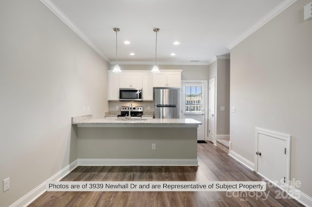 kitchen with pendant lighting, white cabinets, crown molding, light stone countertops, and appliances with stainless steel finishes