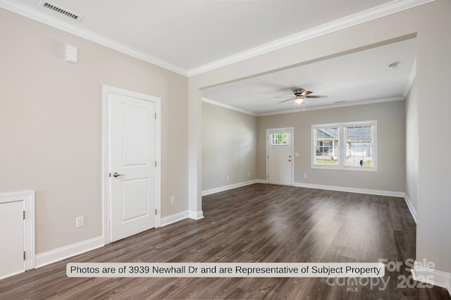 spare room featuring ceiling fan, dark wood-type flooring, and ornamental molding